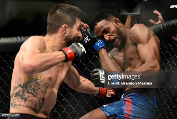 Carlos Condit punches Neil Magny in their welterweight bout during the UFC 219 event inside T-Mobile Arena on December 30, 2017 in Las Vegas, Nevada.