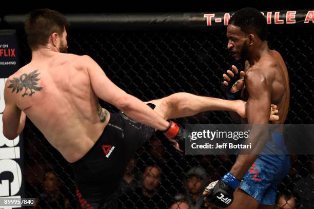 Carlos Condit kicks Neil Magny in their welterweight bout during the UFC 219 event inside T-Mobile Arena on December 30, 2017 in Las Vegas, Nevada.