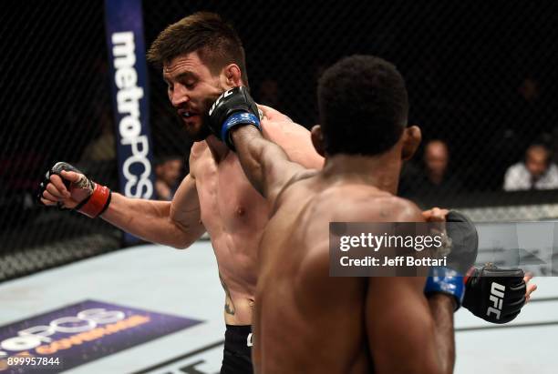 Neil Magny punches Carlos Condit in their welterweight bout during the UFC 219 event inside T-Mobile Arena on December 30, 2017 in Las Vegas, Nevada.