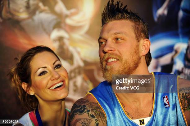 Star Chris Andersen of the Denver Nuggets and his wife attend a fan meeting at Sanlitun Village on August 21, 2009 in Beijing, China.