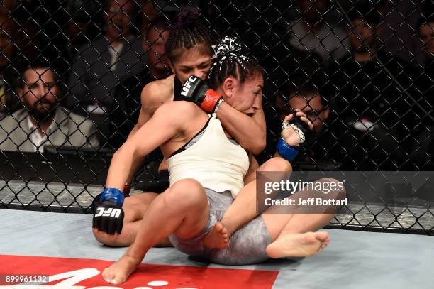 Cynthia Calvillo attempts a rear choke submission against Carla Esparza in their women's strawweight bout during the UFC 219 event inside T-Mobile...