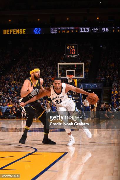 Brandan Wright of the Memphis Grizzlies handles the ball against JaVale McGee of the Golden State Warriors on December 30, 2017 at ORACLE Arena in...
