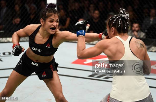 Cynthia Calvillo punches Carla Esparza in their women's strawweight bout during the UFC 219 event inside T-Mobile Arena on December 30, 2017 in Las...