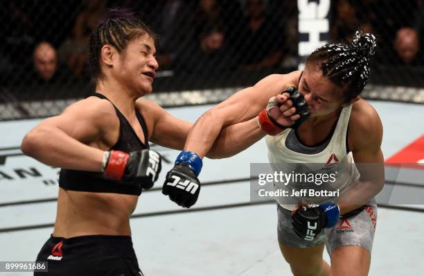 Carla Esparza and Cynthia Calvillo trade punches in their women's strawweight bout during the UFC 219 event inside T-Mobile Arena on December 30,...