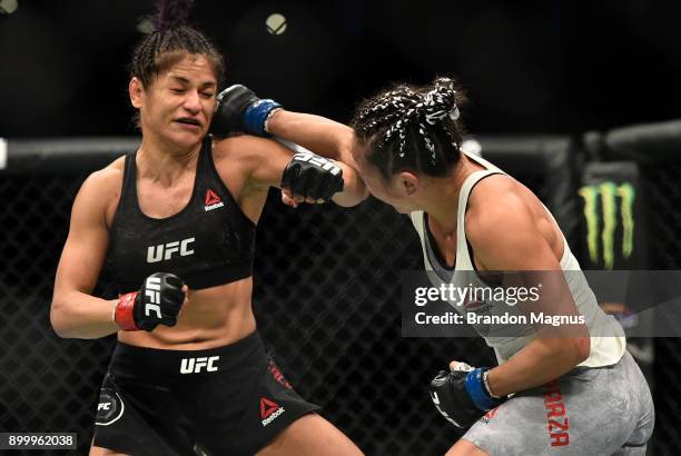 Carla Esparza punches Cynthia Calvillo in their women's strawweight bout during the UFC 219 event inside T-Mobile Arena on December 30, 2017 in Las...