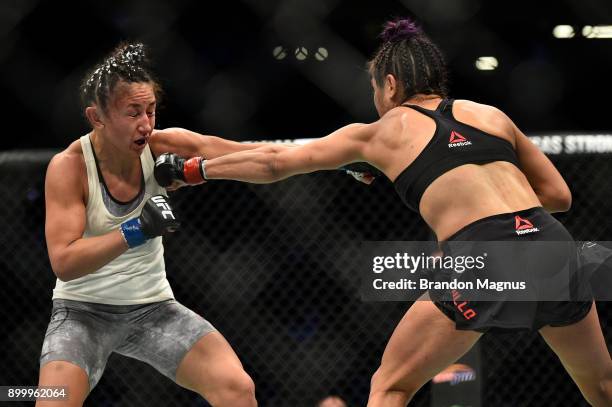 Cynthia Calvillo punches Carla Esparza in their women's strawweight bout during the UFC 219 event inside T-Mobile Arena on December 30, 2017 in Las...