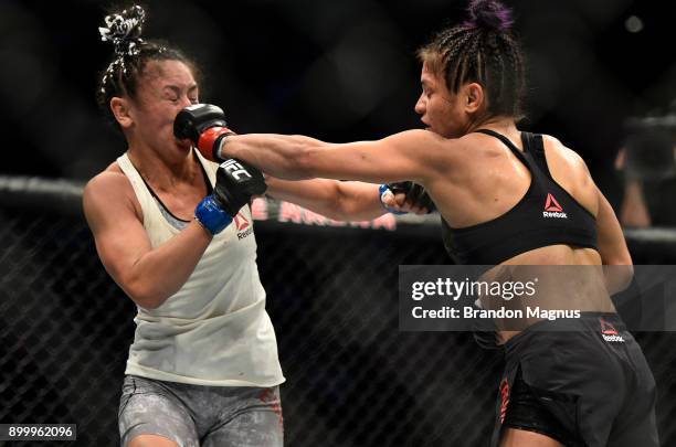 Cynthia Calvillo punches Carla Esparza in their women's strawweight bout during the UFC 219 event inside T-Mobile Arena on December 30, 2017 in Las...