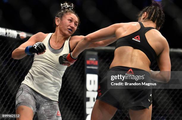 Carla Esparza punches Cynthia Calvillo in their women's strawweight bout during the UFC 219 event inside T-Mobile Arena on December 30, 2017 in Las...