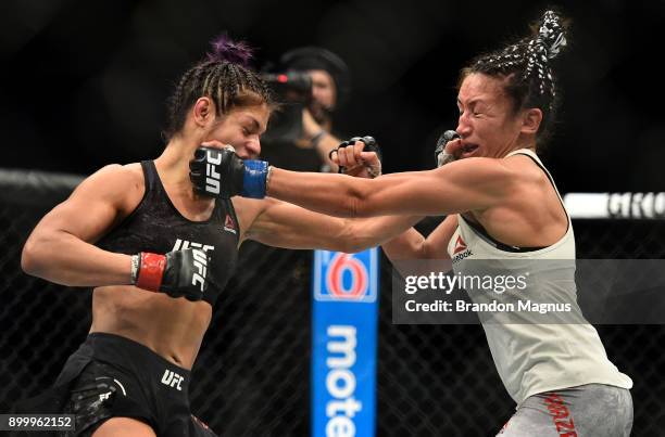 Cynthia Calvillo punches Carla Esparza in their women's strawweight bout during the UFC 219 event inside T-Mobile Arena on December 30, 2017 in Las...