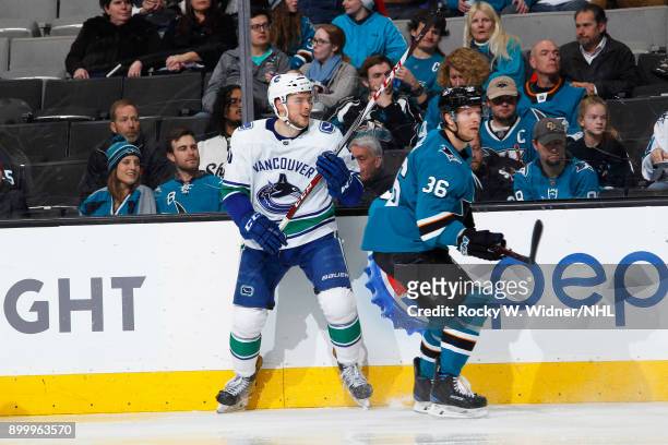 Jannik Hansen of the San Jose Sharks skates against Brendan Gaunce of the Vancouver Canucks at SAP Center on December 21, 2017 in San Jose,...