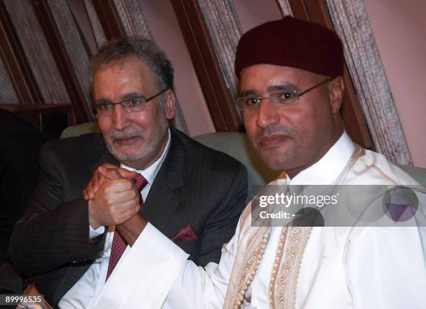 Libyan leader Moamer Kadhafi's son Seif al-Islam holds hands with freed Lockerbie bomber Abdelbaset Ali Mohmet al-Megrahi, the sole Libyan convicted...