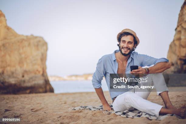 enjoying music at the beach - cell phone using beach stock pictures, royalty-free photos & images