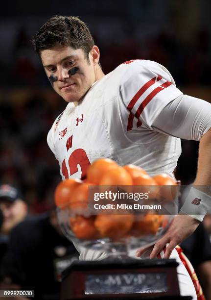 Alex Hornibrook of the Wisconsin Badgers celebrates after winning the MVP trophy of the 2017 Capital One Orange Bowl against the Miami Hurricanes...