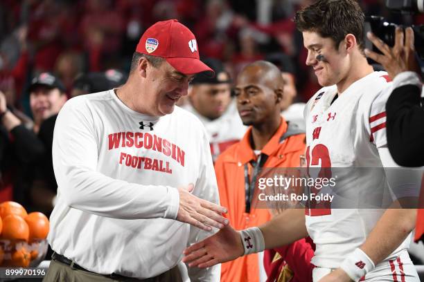 Head coach Paul Chryst shakes hands with Alex Hornibrook of the Wisconsin Badgers after the 2017 Capital One Orange Bowl at Hard Rock Stadium on...