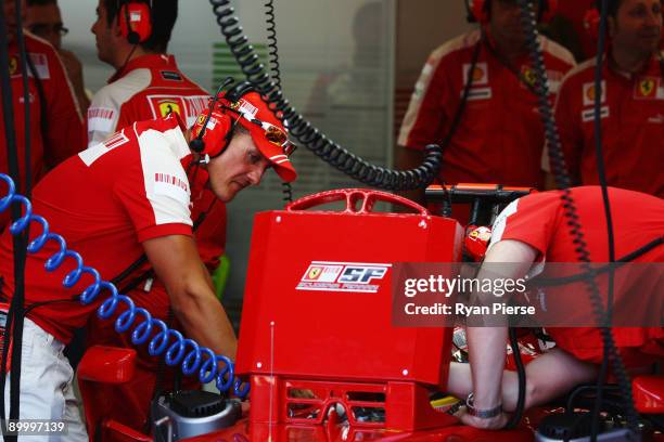 Former Ferrari F1 World Champion Michael Schumacher gives advice to Luca Badoer of Italy during the final practice session prior to qualifying for...