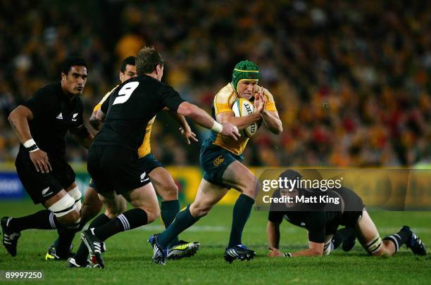 Matt Giteau of the Wallabies takes on the All Blacks defence during the 2009 Tri Nations series Bledisloe Cup match between the Australian Wallabies...