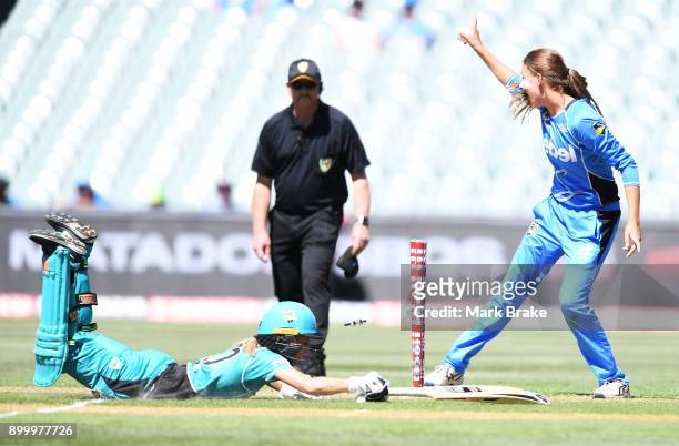 Alex Price of the Adelaide Strikers takes off the bails Alex Price of the Adelaide Strikers Kirby Short of the Brisbane Heat makes her crease during...