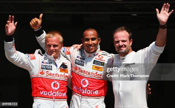 Pole position sitter Lewis Hamilton of Great Britain and McLaren Mercedes celebrates with in parc ferme with second placed Heikki Kovalainen of...