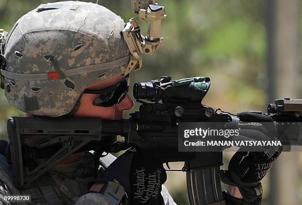 Staff Sergeant Robert Brunner secures an area during a mission at a village in the Baraki Barak district of Logar Province on August 22, 2009. US...