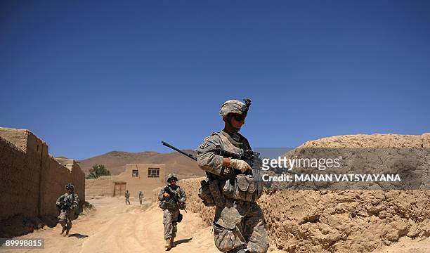 Soldiers from the 1st Platoon Alpha 3-71 Cavalry patrol a village in the Baraki Barak district of Logar Province on August 22, 2009. US President...