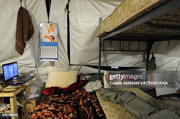 Private First Class Thomas Fox from the 1st Platoon Alpha 3-71 Cavalry listens to music as he rests in his barracks before leaving for a mission at...