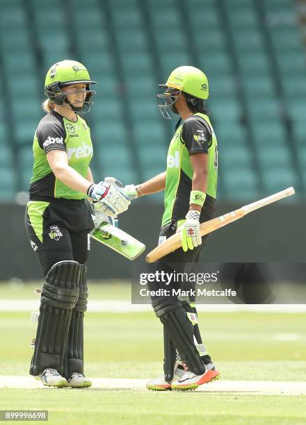 Alex Blackwell of the Thunder and Harmanpreet Kaur of the Thunder celebrate victory in the Women's Big Bash League match between the Sydney Thunder...