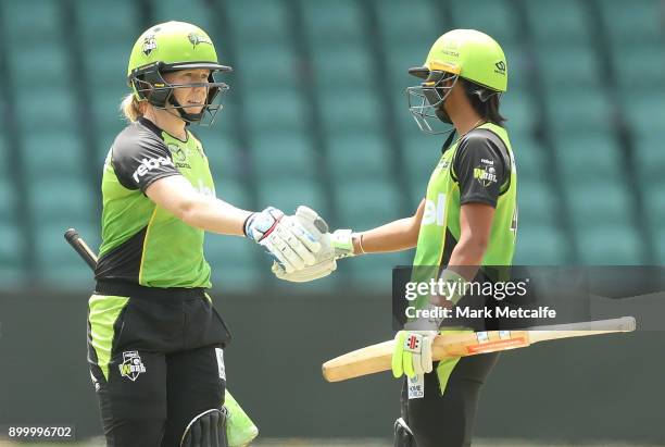 Alex Blackwell of the Thunder and Harmanpreet Kaur of the Thunder celebrate victory in the Women's Big Bash League match between the Sydney Thunder...