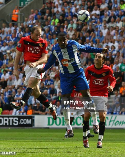 Wayne Rooney of Manchester United scores the opening goal during the Barclays Premier League match between Wigan Athletic and Manchester United at...