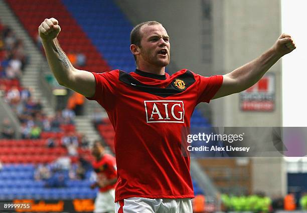 Wayne Rooney of Manchester United celebrates after scoring the opening goal during the Barclays Premier League match between Wigan Athletic and...