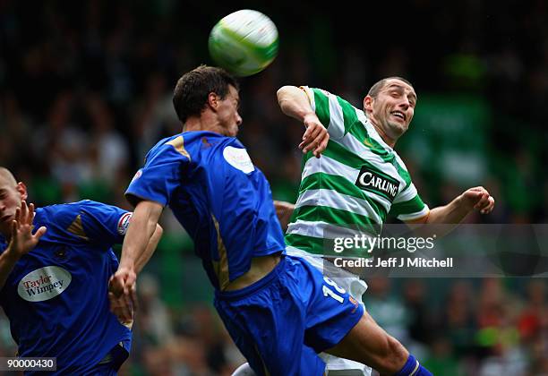 Scott McDonald of Celtic tackles Graham Gartland of St Johnstone during the Clydesdale Bank Scottish Premier league match between Celtic and St...
