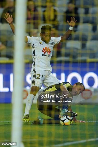 Roy Krishna of the Phoenix contests the ball against Alan Baro of the Mariners during the round 13 A-League match between the Central Coast Mariners...