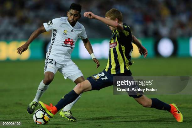 Roy Krishna of the Phoenix contests the ball against the Mariners defence during the round 13 A-League match between the Central Coast Mariners and...