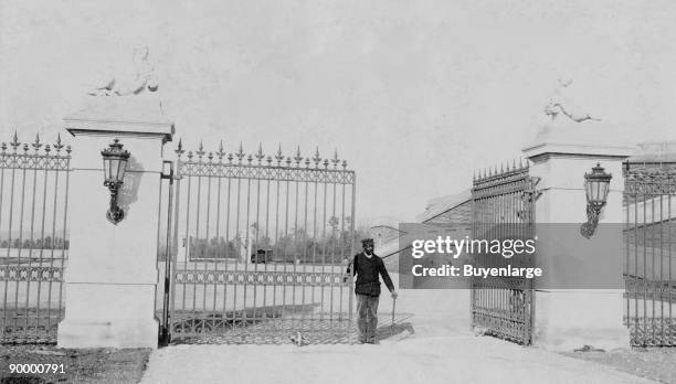 African American man standing by a half-opened entry gate at the Biltmore Estate.