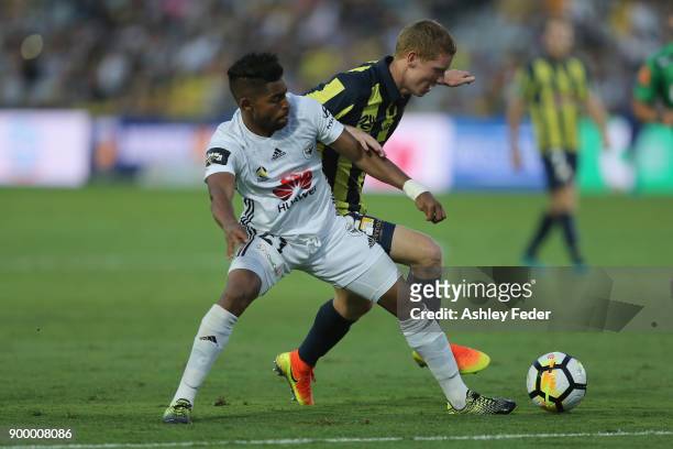 Roy Krishna of the Phoenix contests the ball against Kye Rowles of the Mariners during the round 13 A-League match between the Central Coast Mariners...