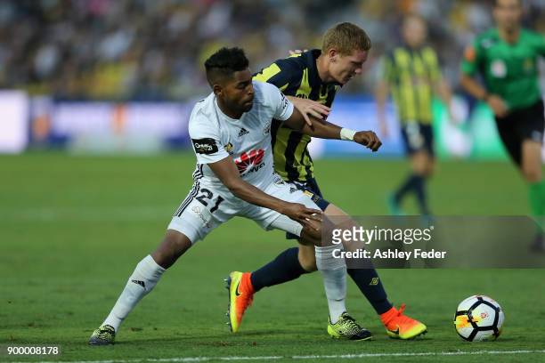 Roy Krishna of the Phoenix contests the ball against Kye Rowles of the Mariners during the round 13 A-League match between the Central Coast Mariners...