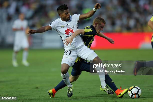 Roy Krishna of the Phoenix contests the ball against Kye Rowles of the Mariners during the round 13 A-League match between the Central Coast Mariners...