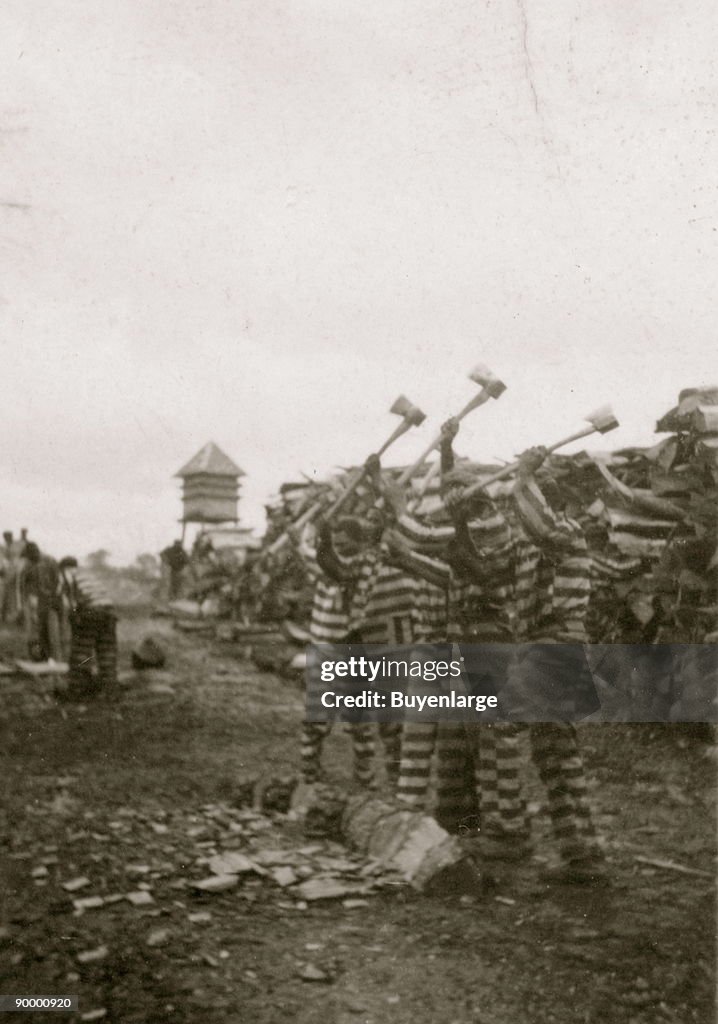 African American convicts working with axes, watchtower in background, Reed Camp, South Carolina