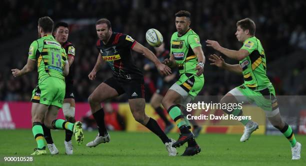 Luther Burrell of Northampton off loads the ball during the Aviva Premiership Big Game 10 match between Harlequins and Northampton Saints at...