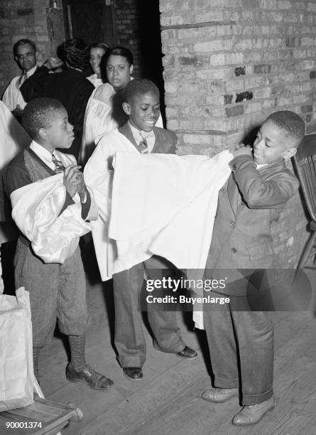 African American Boys of children's choir putting on their robes. Chicago, Illinois