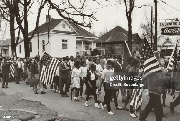 Participants, some carrying American flags, marching in the civil rights march from Selma to Montgomery, Alabama in 1965