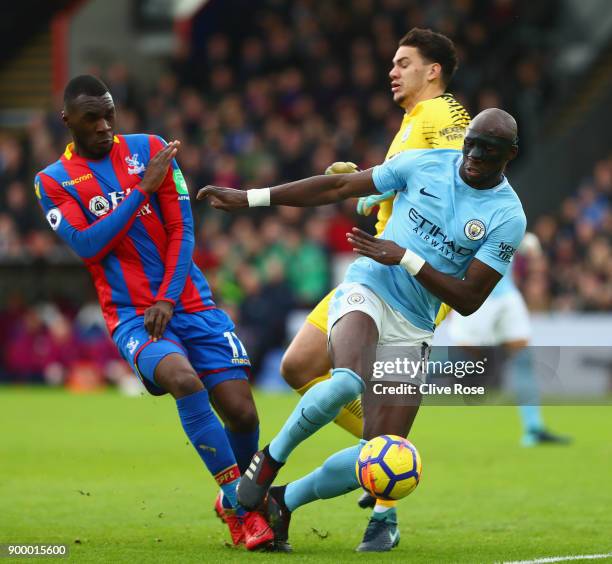 Christian Benteke of Crystal Palace is foiled by Eliaquim Mangala and Ederson of Manchester City during the Premier League match between Crystal...