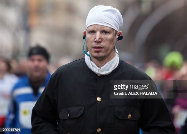 Runner is dressed as a chimney sweeper while taking part in the 41st Vienna New Year's Eve run on the Ringstrasse on December 31, 2017 in Vienna. The...