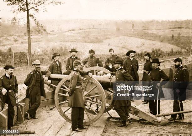 Atlanta, Ga. General William T. Sherman, leaning on breach of gun, and staff at Federal Fort No. 7