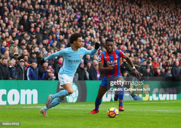 Leroy Sane of Manchester City is watched by Timothy Fosu-Mensah of Crystal Palace during the Premier League match between Crystal Palace and...