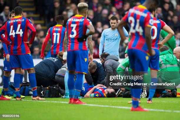 Players from both sides look concerned as Crystal Palace's Scott Dann is treated for an injury during the Premier League match between Crystal Palace...