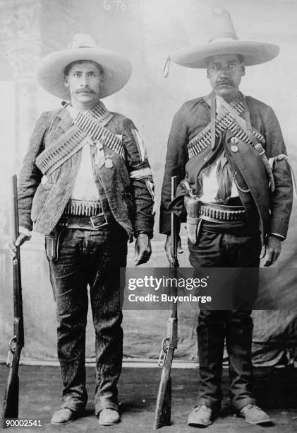 Pancho Villa's Men Urbino & Iluarte stand at attention with rifles, bandoliers and Pistols