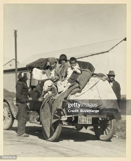 North to California, migrant works stack their cars with children and life's possessions to work the farm crops of fertile valleys.
