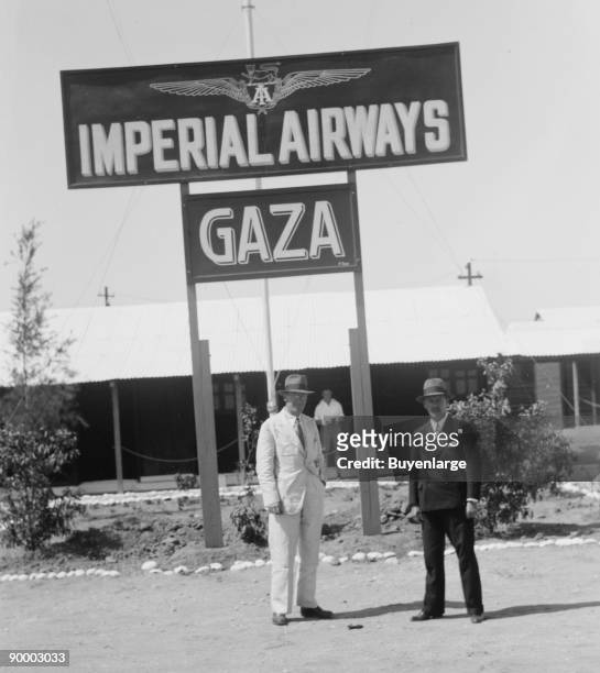 During the British Mandate Over Palestine, Gaza had an air terminal for British Imperial Airways; Two men in western suits pose under the sign