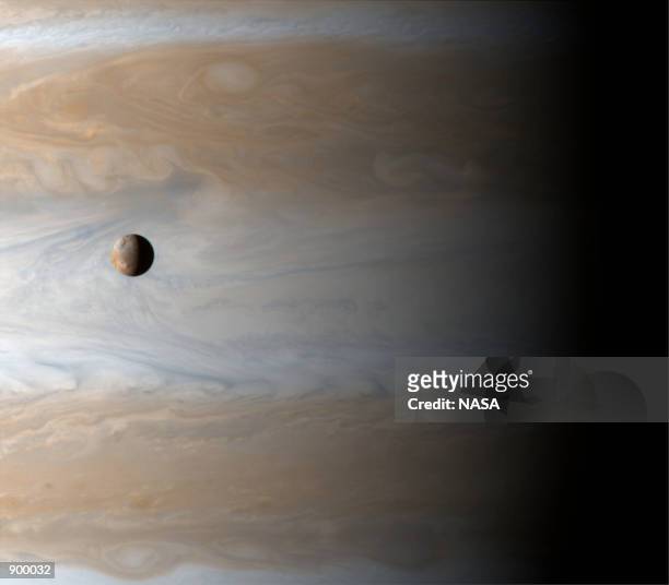 Gliding past the planet Jupiter, the Cassini spacecraft captures this awe inspiring view of active Io, Jupiter's third largest satellite, with the...