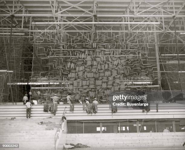 Japanese American internees at work making camouflage nets at the Santa Anita Assembly Center at Santa Anita Racetrack in Arcadia, California, 1942....